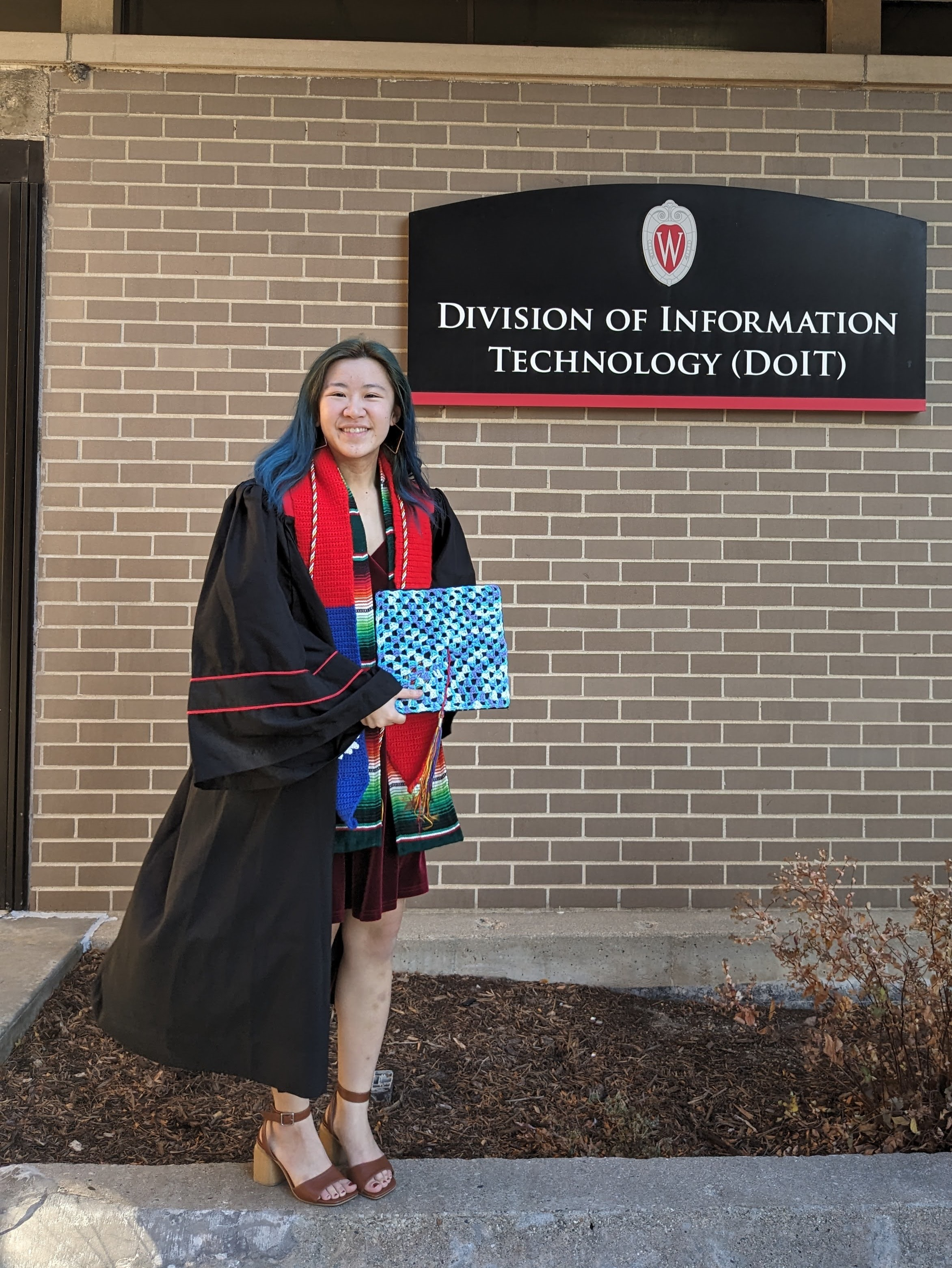 Rachael in graduation gown at the DoIT Help Desk